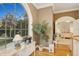 Bright hallway space featuring a sewing machine near a large window and entry to a bedroom at 919 Ballinger Rd, Lutz, FL 33548
