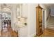 Hallway with desk area, decorative cabinet, hardwood floors and view of lake through the arched window at 919 Ballinger Rd, Lutz, FL 33548