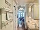 Hallway with dark wood floors, white cabinets, and view into a living room with lake view at 919 Ballinger Rd, Lutz, FL 33548