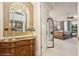 Hallway view into a bedroom with water view. A large decorative mirror and credenza highlight the entryway at 919 Ballinger Rd, Lutz, FL 33548