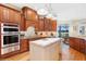Gourmet kitchen featuring custom wood cabinetry, granite countertops, and stainless steel appliances at 919 Ballinger Rd, Lutz, FL 33548