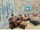 Cozy living room with a comfortable leather seating area and inviting decor with great lighting at 919 Ballinger Rd, Lutz, FL 33548