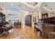 Elegant living room featuring soaring ceilings, lake views, and a grand piano at 919 Ballinger Rd, Lutz, FL 33548