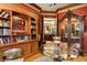 Sophisticated sitting room features wood bookcase, glass table and elegant decor at 919 Ballinger Rd, Lutz, FL 33548