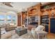 Cozy living room with custom built-ins, a large window offering serene lake views, and comfortable seating at 919 Ballinger Rd, Lutz, FL 33548
