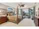 Spacious main bedroom featuring a four-poster bed, water view, and a sitting area at 919 Ballinger Rd, Lutz, FL 33548