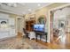 Office space with hardwood floors, a built-in desk, and view to adjacent living room at 919 Ballinger Rd, Lutz, FL 33548