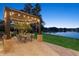 Picturesque outdoor patio with a dining set, gazebo, and scenic waterfront view, perfect for entertaining at 919 Ballinger Rd, Lutz, FL 33548