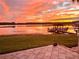 Beautiful sunset over the lake, viewed from the home's backyard patio at 919 Ballinger Rd, Lutz, FL 33548
