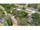 Aerial view displaying the home's setting amidst mature trees in a well-established residential neighborhood at 1010 Oakhill St, Seffner, FL 33584