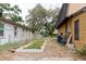 Fenced backyard featuring mature trees, garden, and exterior home systems at 1010 Oakhill St, Seffner, FL 33584
