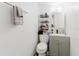 This bathroom offers a modern vanity with open shelving and neutral color palette at 1010 Oakhill St, Seffner, FL 33584