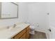 Bright bathroom featuring a modern sink, toilet, and wood look flooring at 1010 Oakhill St, Seffner, FL 33584