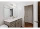 Bathroom features a gray vanity with a marble countertop and a view into the entryway at 1010 Oakhill St, Seffner, FL 33584