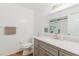 Bright bathroom features a gray vanity, white countertop, and a shower with glass doors at 1010 Oakhill St, Seffner, FL 33584