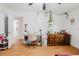Bright bedroom featuring hardwood floors, plants, a desk and an open doorway at 1010 Oakhill St, Seffner, FL 33584