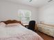 Bright bedroom featuring hardwood floors, a desk, a dresser, and natural light at 1010 Oakhill St, Seffner, FL 33584