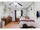 Well-lit bedroom featuring plants, a ceiling fan, hardwood floors, and a window at 1010 Oakhill St, Seffner, FL 33584