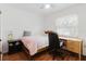Bright bedroom with hardwood floors, featuring a desk, a nightstand, and large windows at 1010 Oakhill St, Seffner, FL 33584