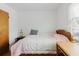 Cozy bedroom featuring hardwood floors, a bedside table, and natural light from the window at 1010 Oakhill St, Seffner, FL 33584