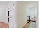 Bright hallway with wood floors leads to the home's front door and upstairs at 1010 Oakhill St, Seffner, FL 33584