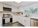 Bright kitchen featuring stainless steel appliances, white cabinets and updated fixtures at 1010 Oakhill St, Seffner, FL 33584