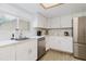 Well-lit kitchen with stainless steel appliances, white cabinets, and modern hardware at 1010 Oakhill St, Seffner, FL 33584