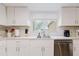 Updated kitchen features white cabinets, stainless steel appliances and modern countertops at 1010 Oakhill St, Seffner, FL 33584