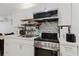 The kitchen area includes white cabinets, stainless steel appliances and tile backsplash at 1010 Oakhill St, Seffner, FL 33584