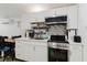 The kitchen area includes white cabinets, stainless steel appliances and a dining area at 1010 Oakhill St, Seffner, FL 33584