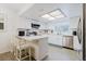 Modern kitchen features sleek appliances, white cabinets and a breakfast bar at 1010 Oakhill St, Seffner, FL 33584