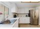 Bright kitchen features modern white cabinets, marble countertops, and stainless steel appliances at 1010 Oakhill St, Seffner, FL 33584
