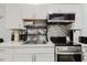 The kitchen has white cabinets, stainless steel appliances and decorative backsplash at 1010 Oakhill St, Seffner, FL 33584