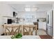 Bright kitchen with white cabinets, island with seating and stainless steel appliances at 1010 Oakhill St, Seffner, FL 33584