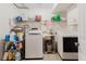 This laundry room is equipped with modern washer and dryer, sink, and convenient storage shelves at 1010 Oakhill St, Seffner, FL 33584