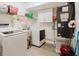 Bright laundry room features modern washer and dryer, sink, storage, and mechanicals at 1010 Oakhill St, Seffner, FL 33584