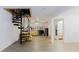 Bright open concept living space with spiral staircase and access to bathroom and desk area at 1010 Oakhill St, Seffner, FL 33584