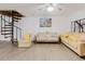 Inviting living room with modern ceiling fan, decor, and decorative spiral staircase at 1010 Oakhill St, Seffner, FL 33584