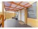 Charming covered porch featuring plank flooring and access to the home at 1010 Oakhill St, Seffner, FL 33584