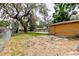 View of backyard with grassy areas and an additional structure at 1010 Oakhill St, Seffner, FL 33584