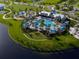 Stunning aerial view of community pool, clubhouse, playground, and lake at 10153 Spruce River Way, Parrish, FL 34219