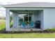 Inviting back patio featuring a seating area, outdoor grill, and a view of the yard at 10153 Spruce River Way, Parrish, FL 34219