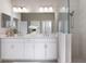 Beautiful bathroom featuring a double vanity with white cabinets and a glass enclosed shower at 10153 Spruce River Way, Parrish, FL 34219
