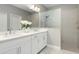 Beautiful bathroom featuring a double vanity with white cabinets and a glass enclosed shower at 10153 Spruce River Way, Parrish, FL 34219
