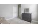 Neutral bedroom with a gray dresser, a soft couch, carpeted floor, and bright white trim at 10153 Spruce River Way, Parrish, FL 34219