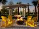 Relaxing firepit area with swing and Adirondack chairs at 10153 Spruce River Way, Parrish, FL 34219