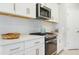 Bright kitchen with white cabinetry, stainless steel appliances, and a gas range cooktop on the countertop at 10153 Spruce River Way, Parrish, FL 34219