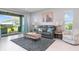 Comfortable living room with sliding glass doors to patio and decorative throw pillows at 10153 Spruce River Way, Parrish, FL 34219