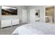 Bright main bedroom featuring a comfortable bed, white furniture, and an ensuite bathroom at 10153 Spruce River Way, Parrish, FL 34219