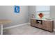 Bright office showcasing a wooden cabinet, modern decor, a window with blinds, and carpeted floor at 10153 Spruce River Way, Parrish, FL 34219